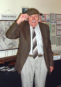 Jim cheerfully tries on a World War I helmet 