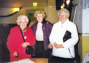 Members pose at the reception desk, including Muriel Lines and her sister Joyce Briscoe